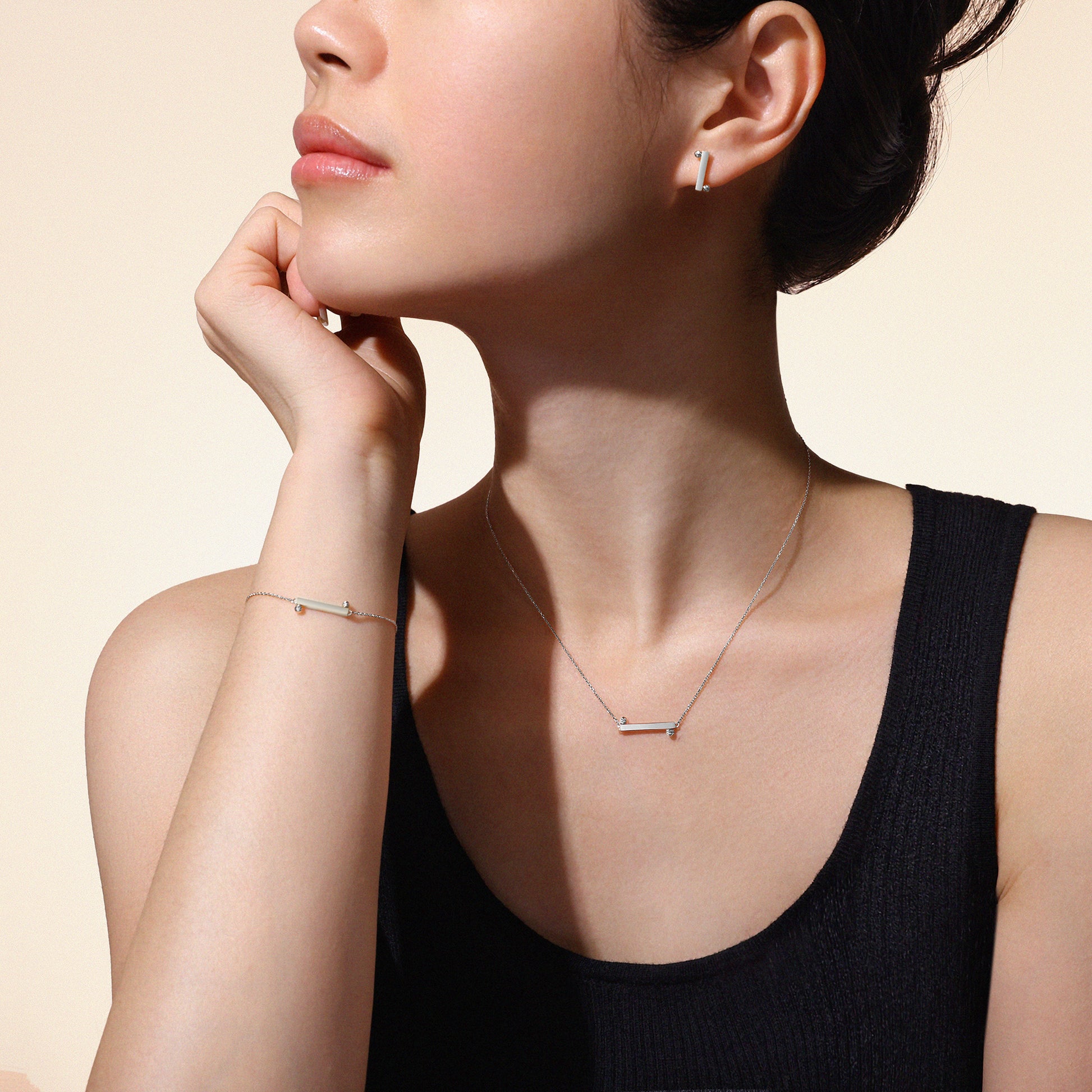 Model wearing matching Balance Collection necklace, bracelet and earrings crafted in solid 18k (750) white gold.
