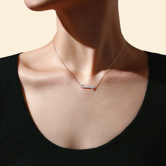 Model wearing The Balance Necklace in solid 18k (750) white gold designed for everyday wear.