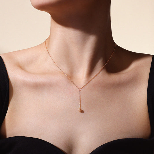 Model wearing The Joy Necklace in solid 18k (750) rose gold designed for everyday wear.